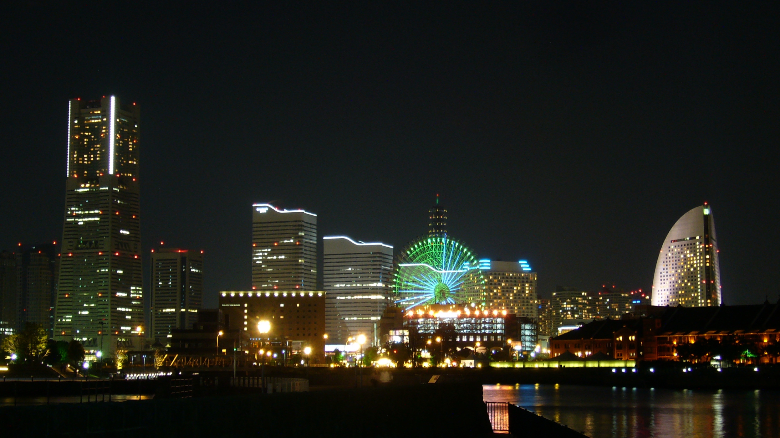 the lights are brightly set on the large city buildings