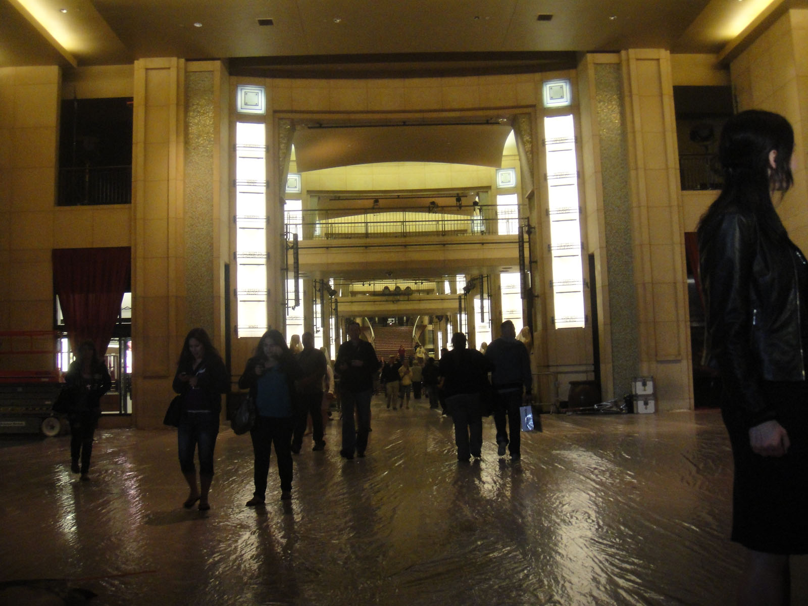 a number of people walking under an archway