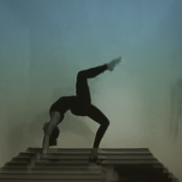 a person doing yoga on steps against a blue sky