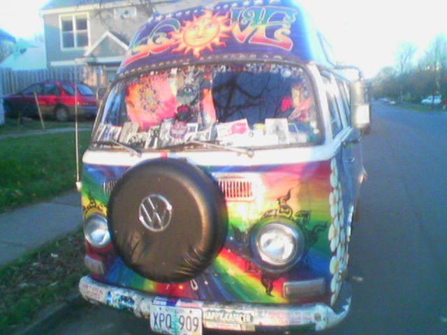 a van with its lights on and decorated with graffiti