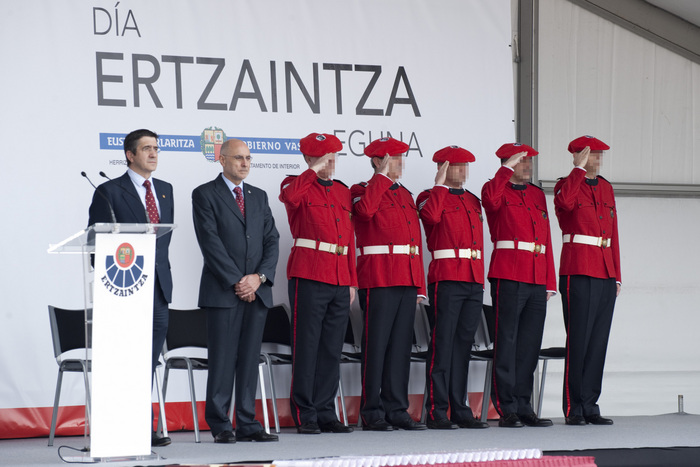 a group of people wearing red uniforms standing near each other