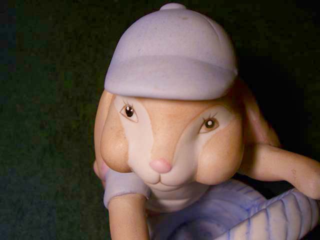 a ceramic figurine of a mouse wearing a white hat