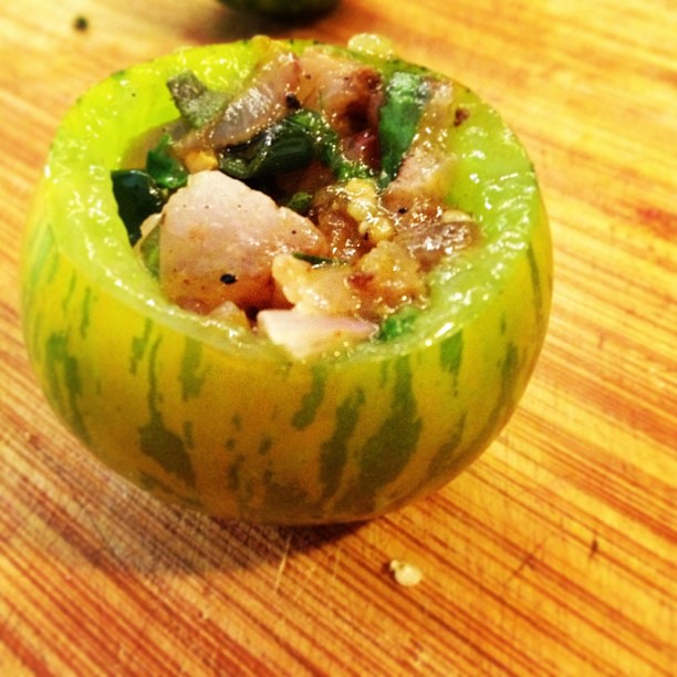 a green pepper stuffed with food is on a table