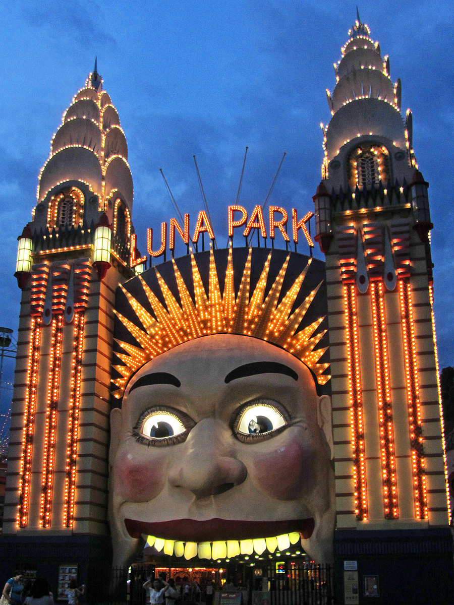 a large building with lit up faces at night