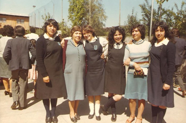 a group of women are posing together on the street