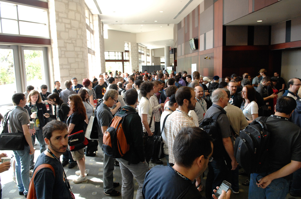 a large group of people line up in an lobby