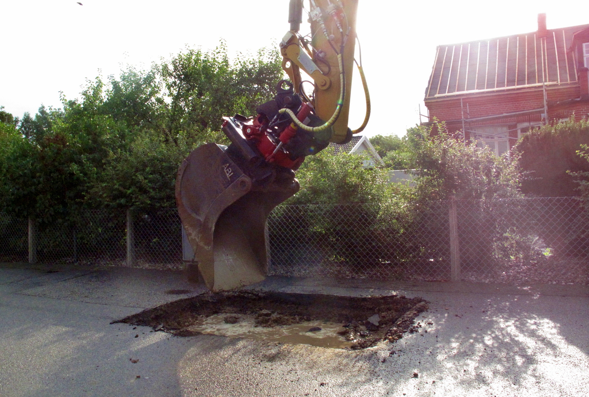 an elephant is working in the street with equipment