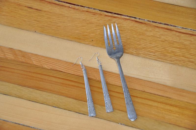a fork and some silverware on some wood