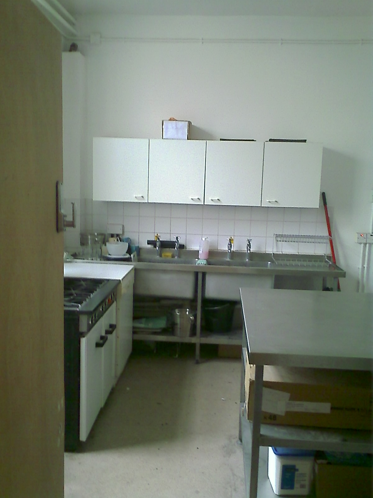 a kitchen with cabinets and an oven that is partially missing