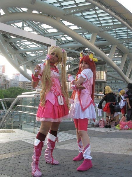 two females dressed in costumes on the side walk