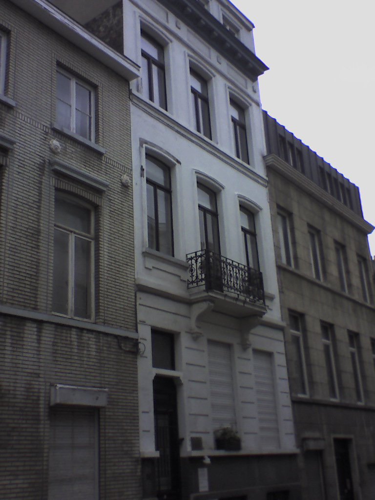 a grey and white row of buildings next to each other