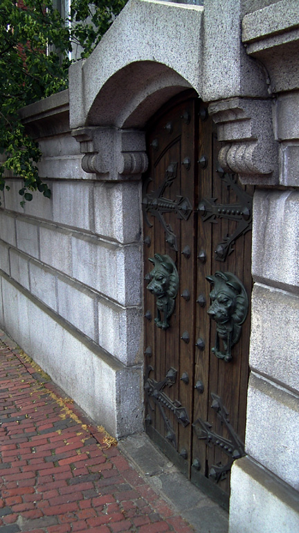 an open wooden door in front of a stone building