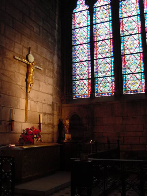 a church with a crucifix, candles and rose petals