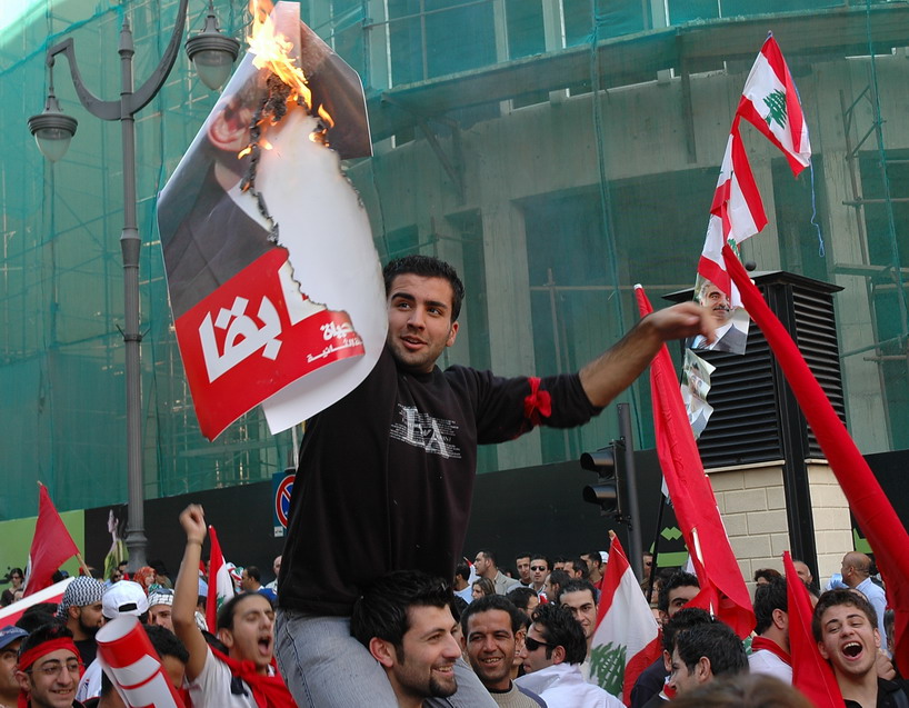 a man holding torches and flags in a crowd