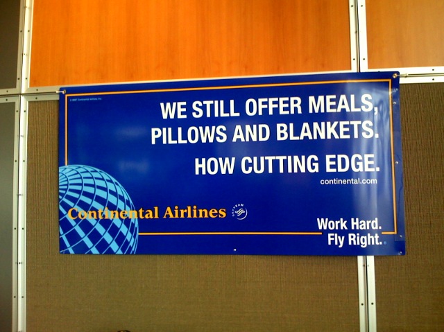 an advertit for commercial airliners is posted on a wall
