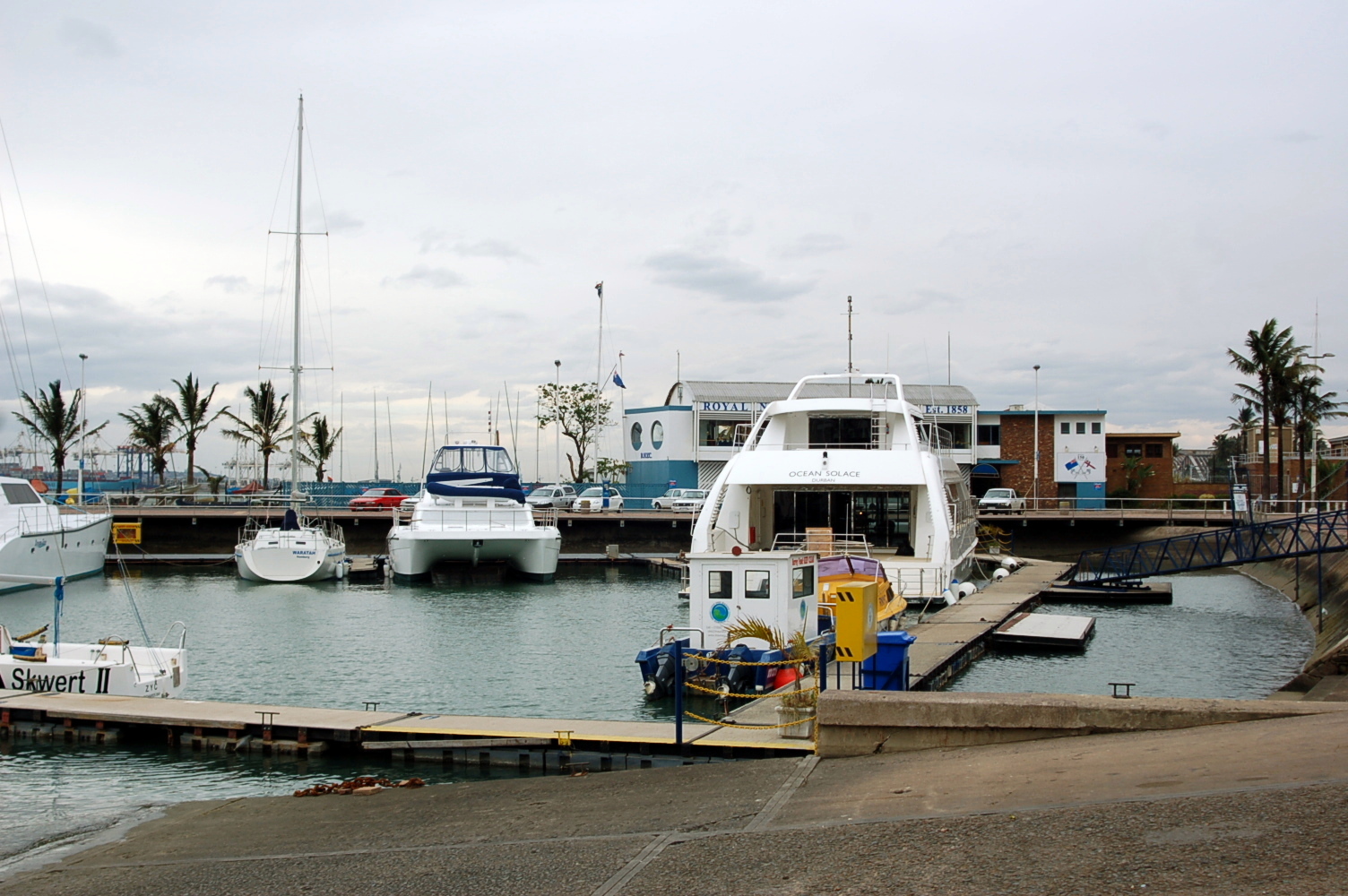 boats docked next to some piers in the ocean