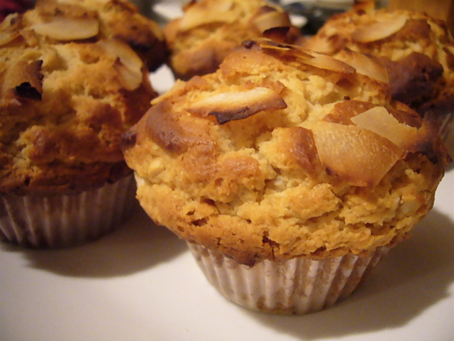 three muffins on a plate with a brown and white pattern