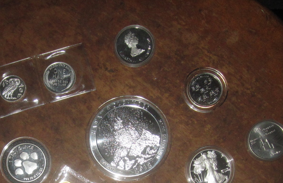 coin sets are sitting on a table and in plastic packages