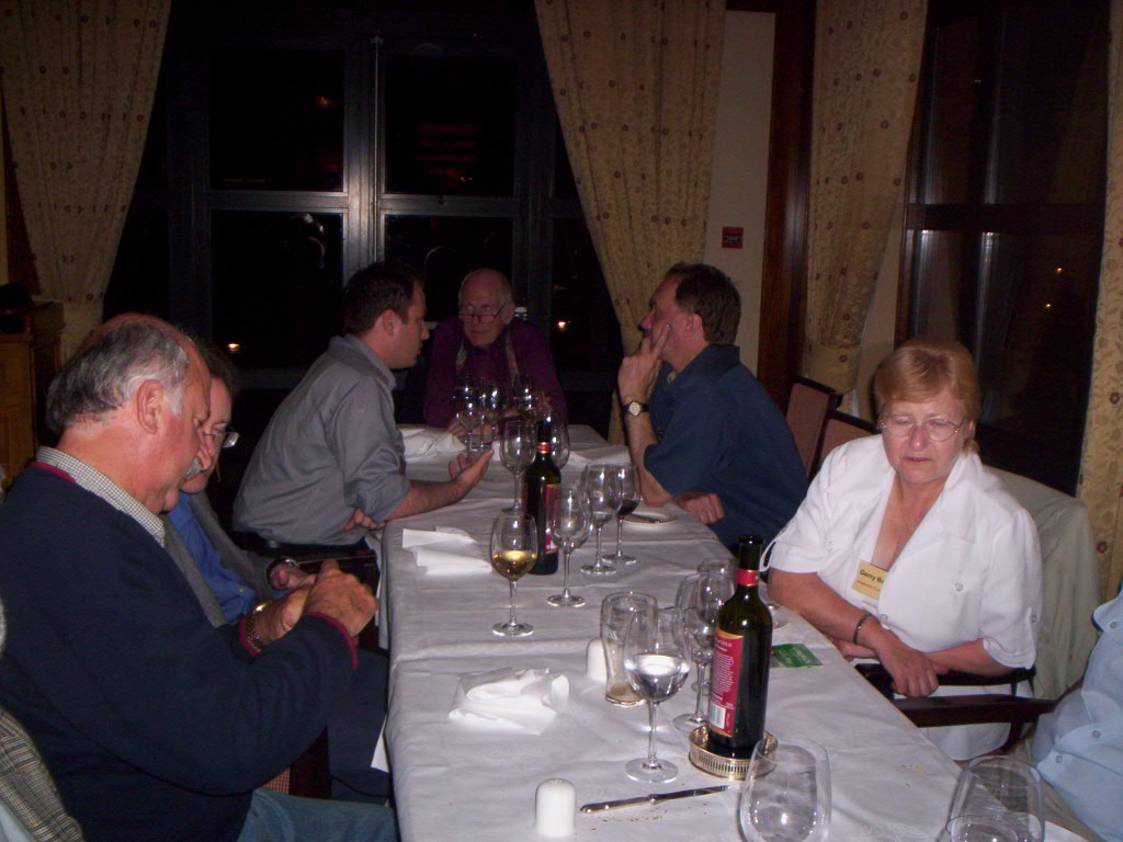 people at a table with wine glasses and bottles