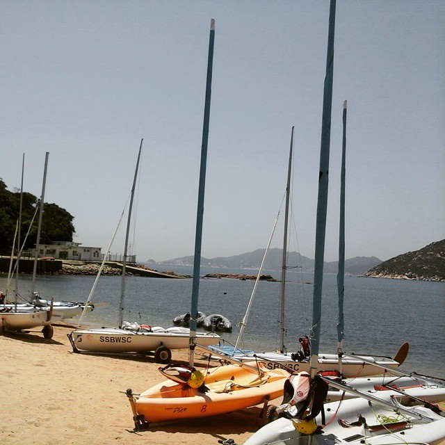 several boats are parked in the sand on the beach