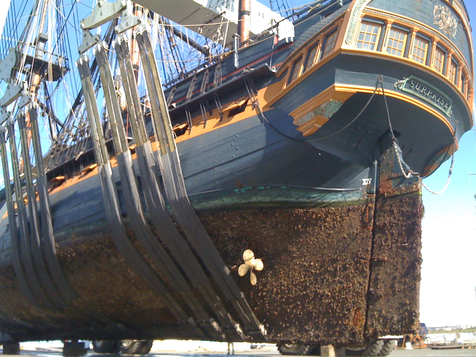 an old sailboat with it's rig still on the dock