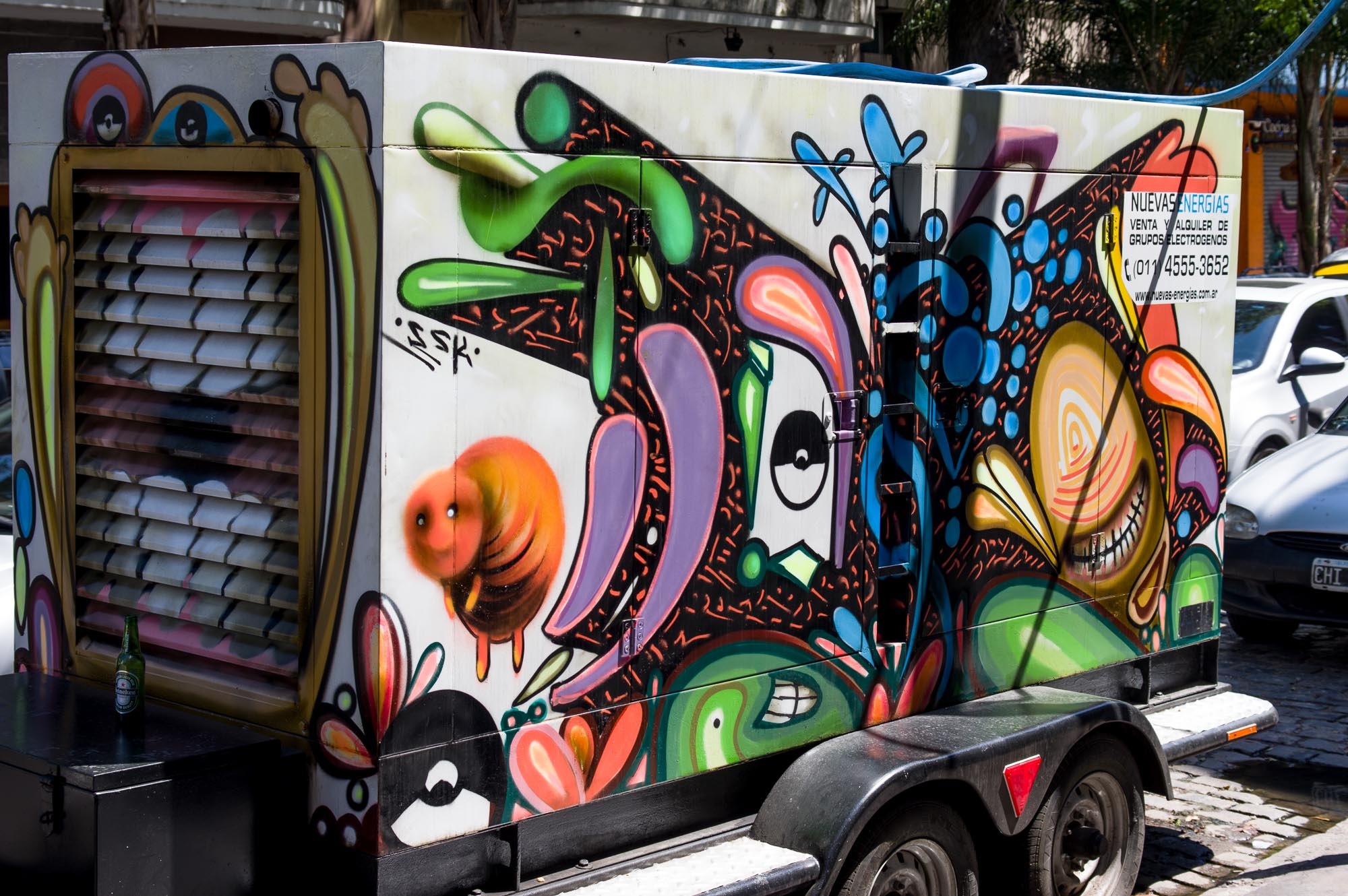 a large truck with colorful graffiti painted on the side