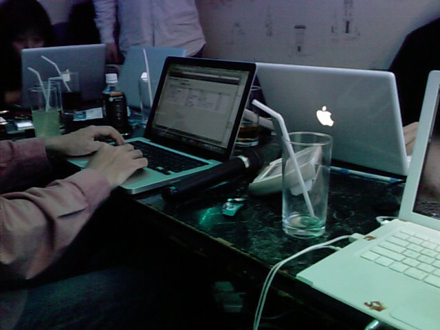 a group of laptops sitting on top of a black desk
