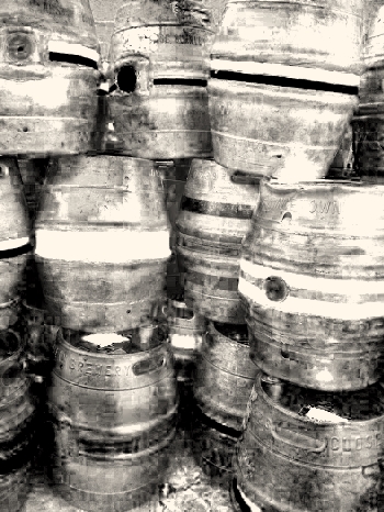 several large barrels lined up on the ground