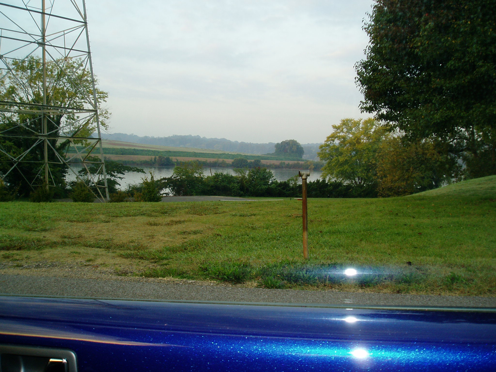 a fence near a road and a large body of water