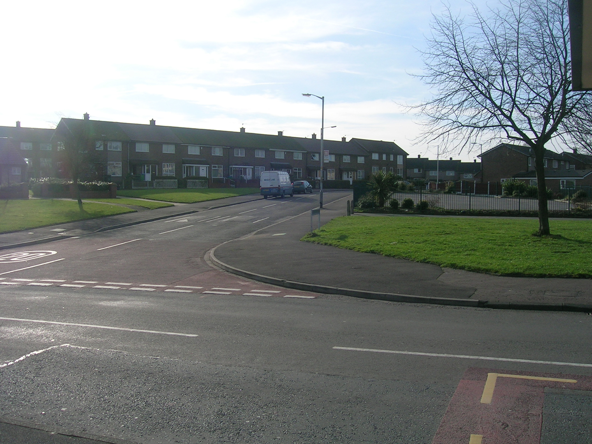 a street has two lanes in front of brick buildings