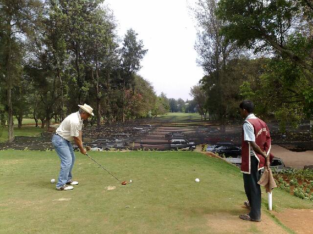 two men play golf near a golf course