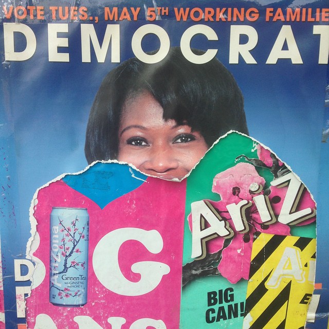 a poster of a woman holding up a sign
