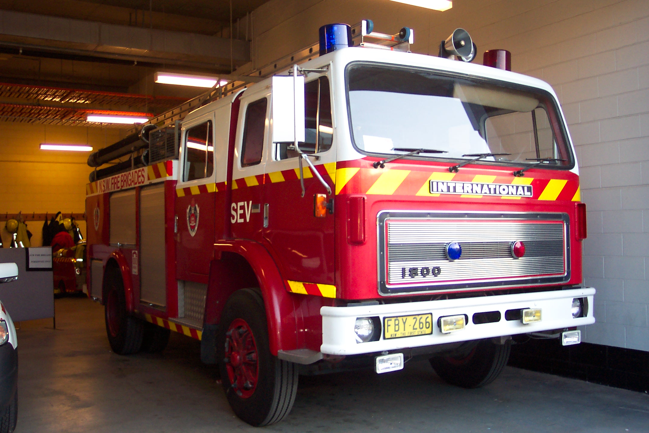 an older fire engine sits on the ground