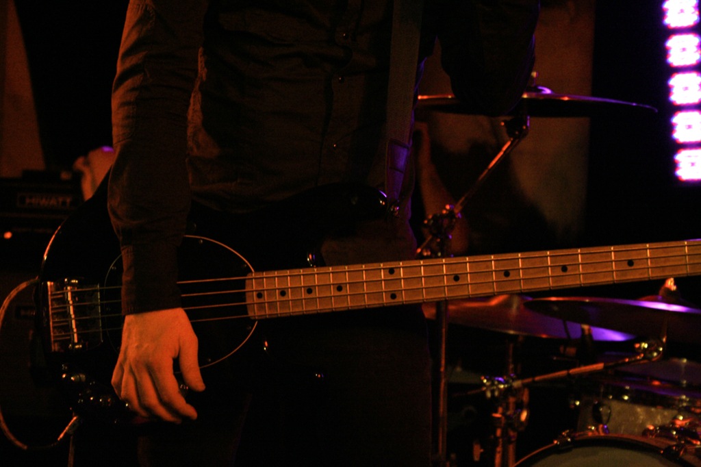 a man with an electric bass guitar in his hand