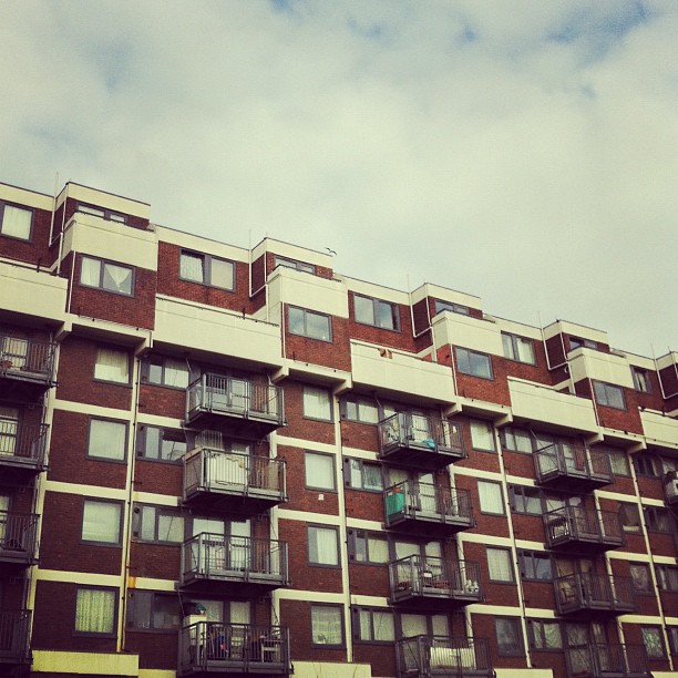 a very tall building with many balconies on it's sides