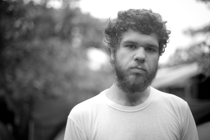 black and white po of a young man wearing a t - shirt