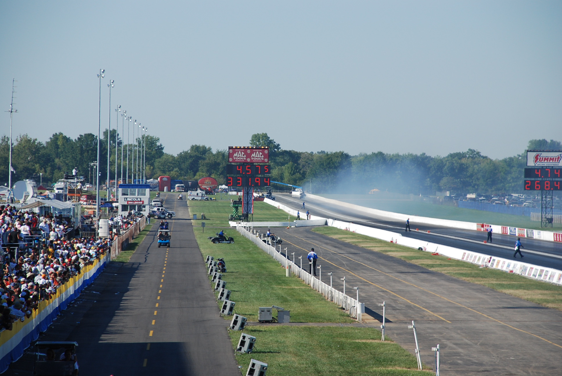 a lot of people that are standing on a race track