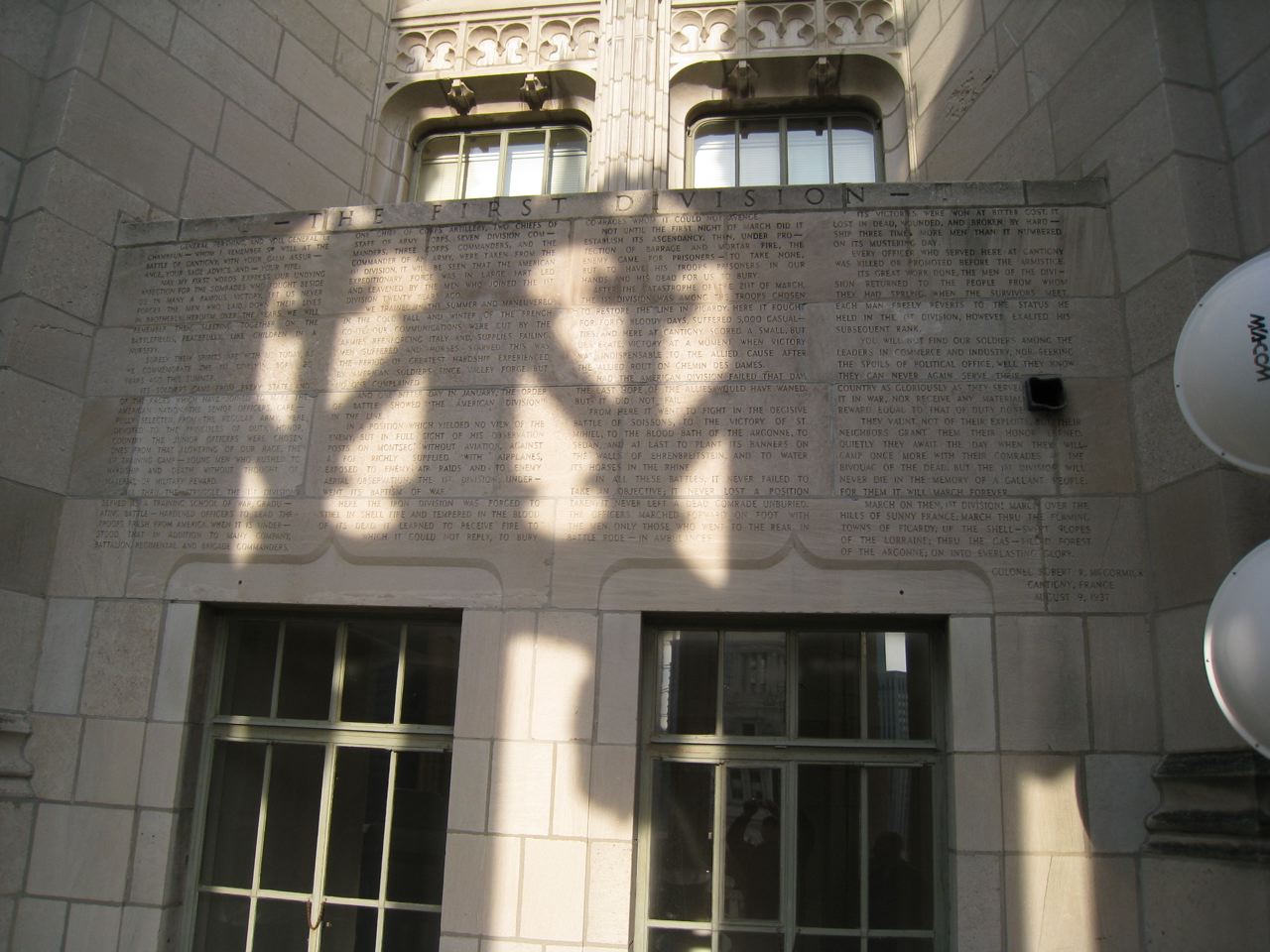 the shadows of an abstract design cast on a brick wall