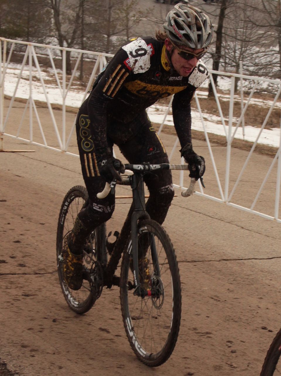 the bicyclist is riding down the dirt path