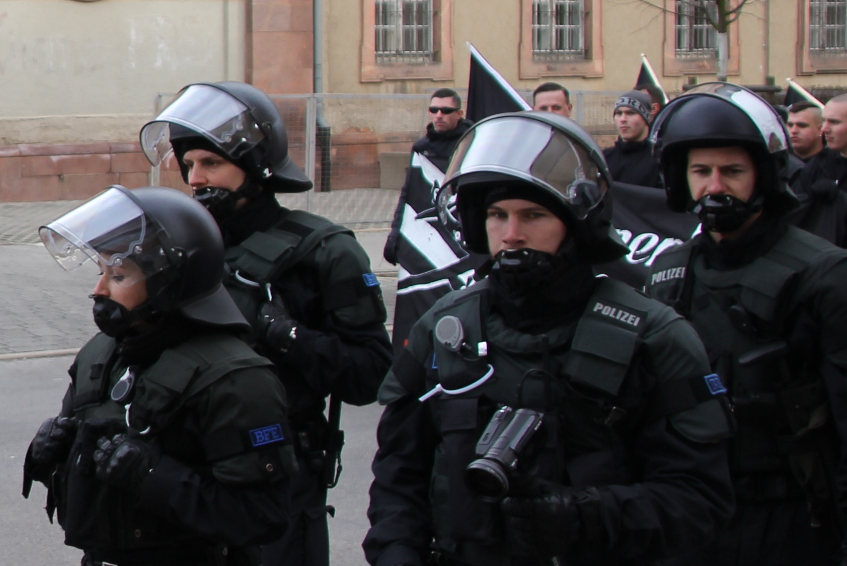 a group of police men with helmets and gas masks