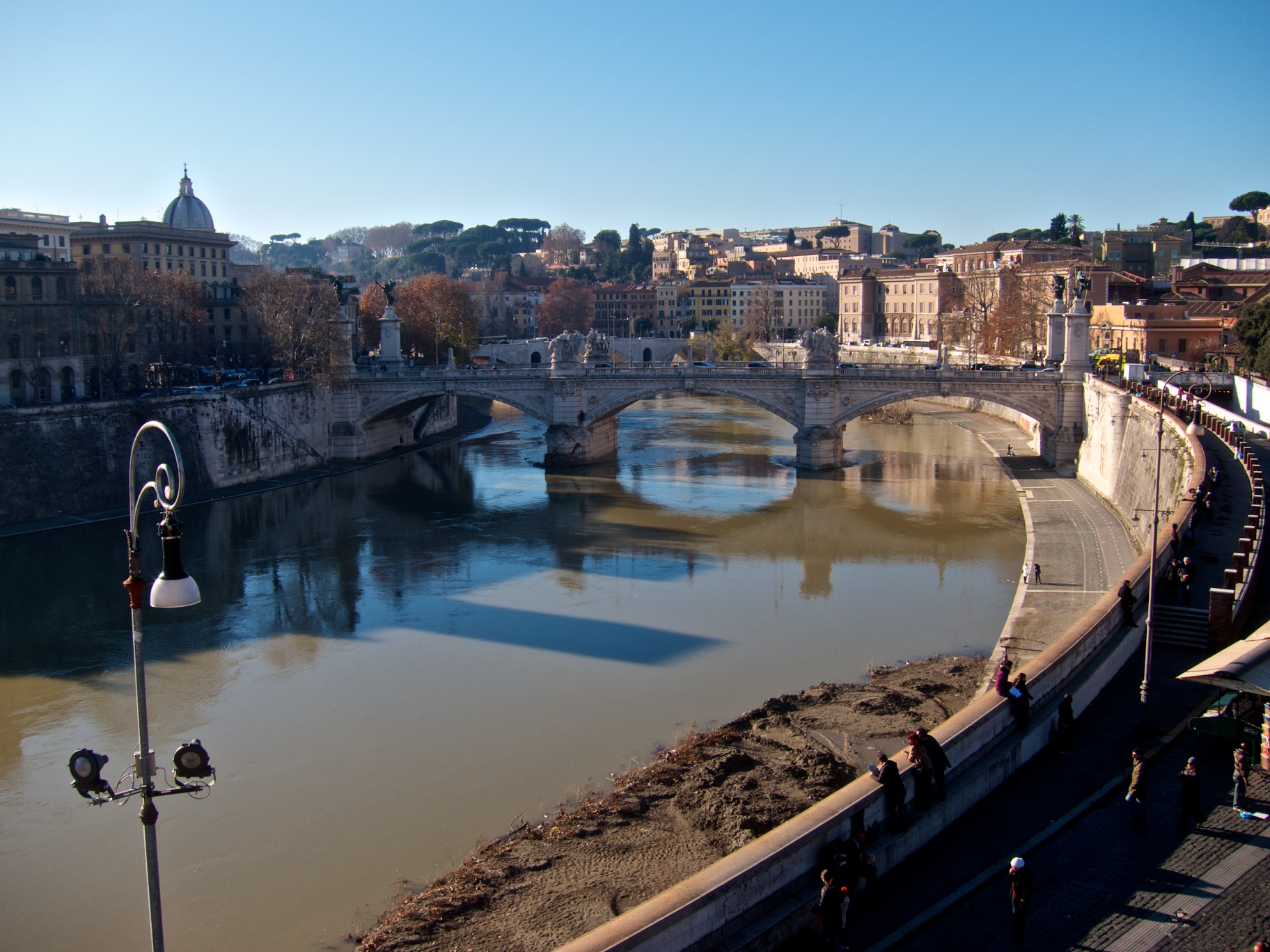 a river with a bridge spanning it and some buildings