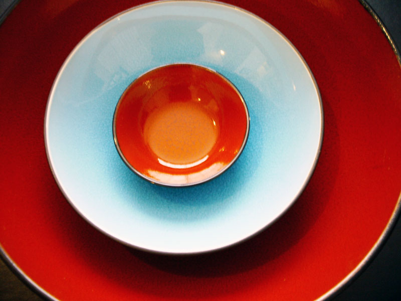 a red and white bowl on a blue plate