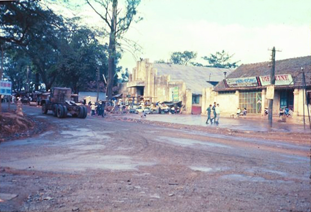 several men on horses and carriages traveling down a street