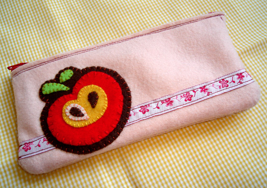 a white case with embroidered design on a yellow tablecloth