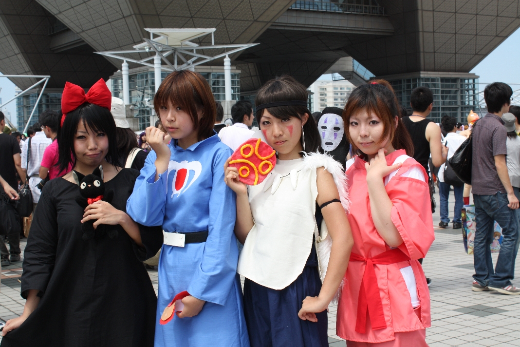 group of asian women dressed in costumes with japanese masks