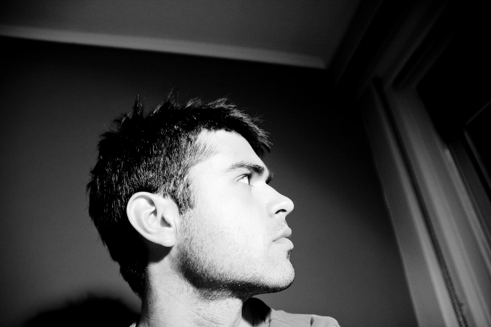 a young man looking off into the distance with dark hair
