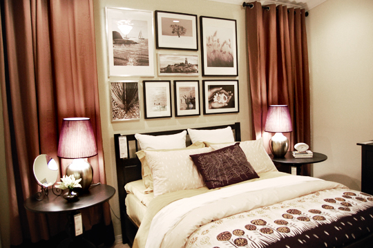 a bedroom with a bed, two tables and a poster on the wall