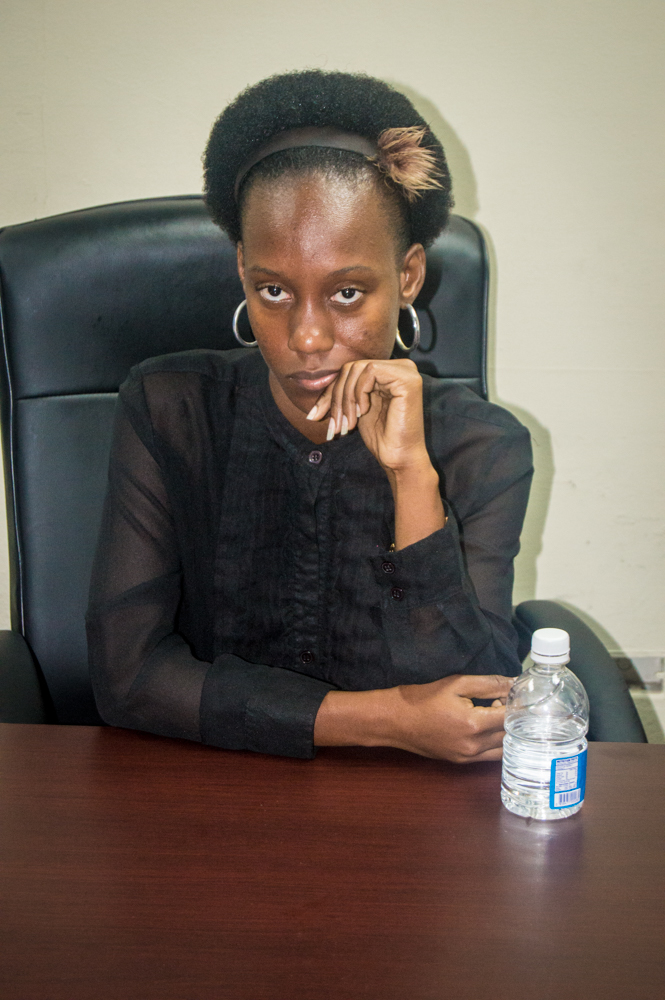 a lady sits at her desk and looks very serious