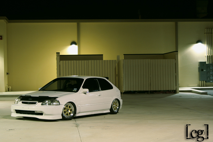 a white car is parked in the driveway