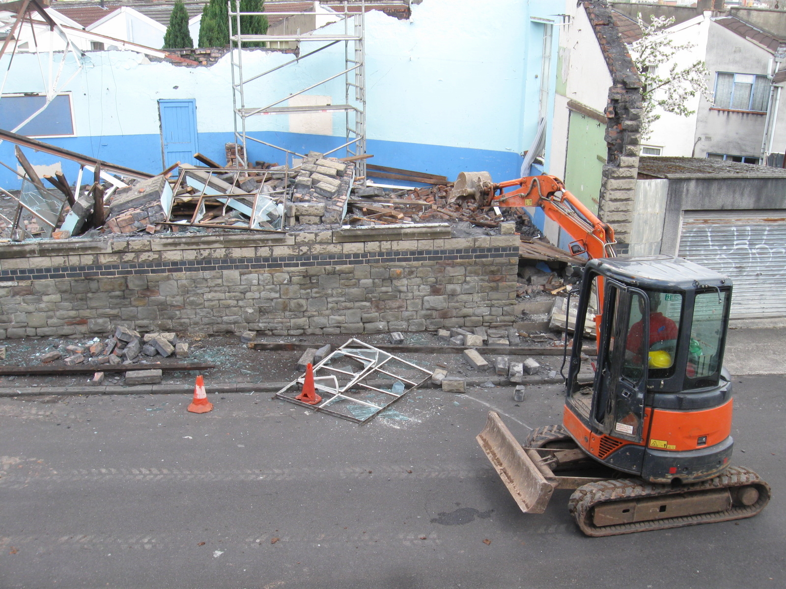 a small construction vehicle near some rubble